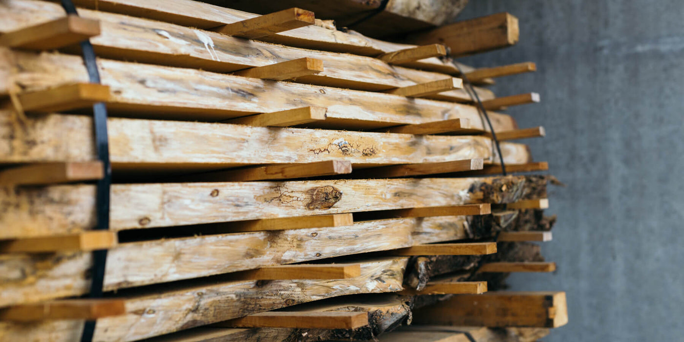 Air drying live edge slabs to mitigate moisture issues.