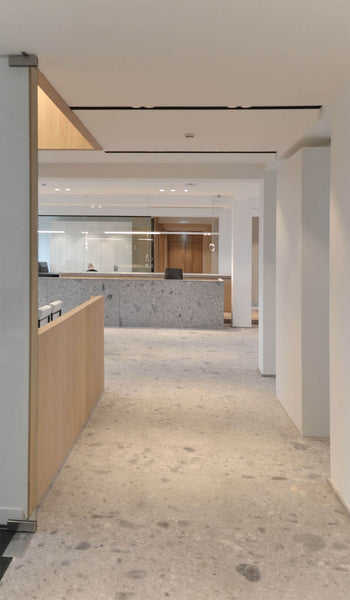 Office building with concrete flooring and wood cubicles.