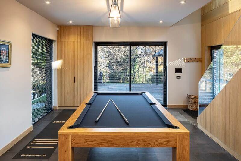 Scandinavian design recreational room with wood paneling on the walls.