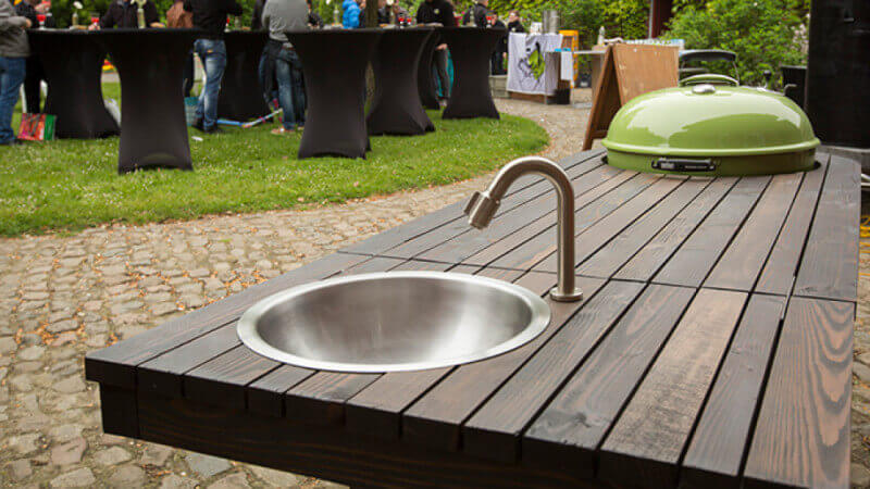 Wooden BBQ cart with built in sink and running water.