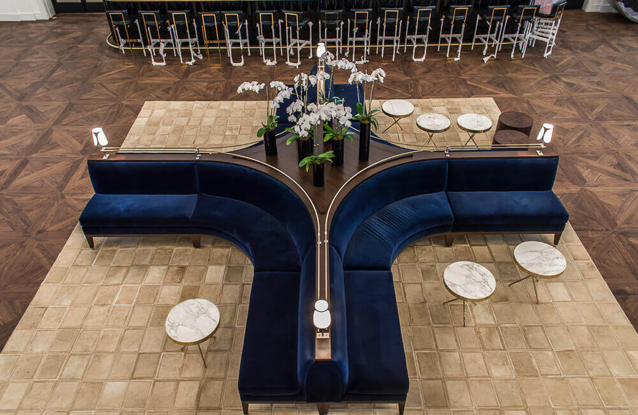 Top-down view of seating area in a lounge with walnut parquet flooring.