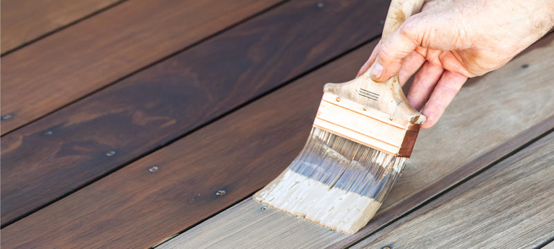DuroGrit, an exterior wood stain, being applied with a brush to cumaru decking