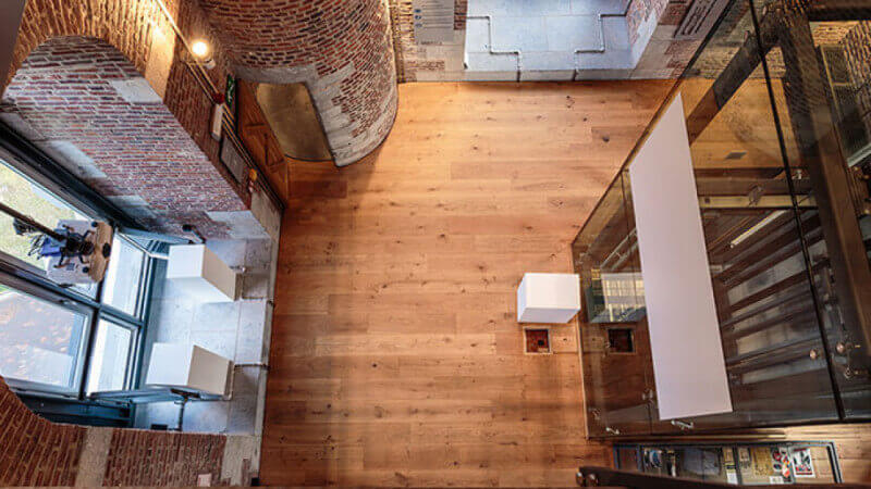 Looking down on the hardwood flooring of the Le Beffroi de Mons.