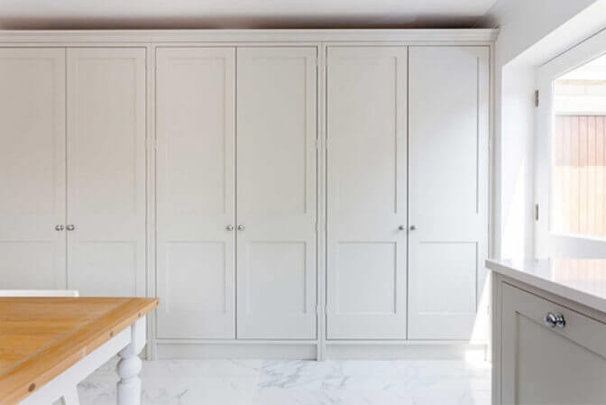 White shaker ceiling height cabinets.