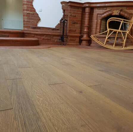 Apartment with hardwood flooring and brick fireplace.