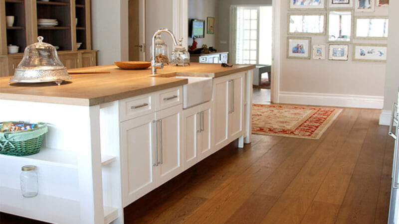 Kitchen in South Africa boasts wide plank wood flooring finished with Rubio Monocoat.