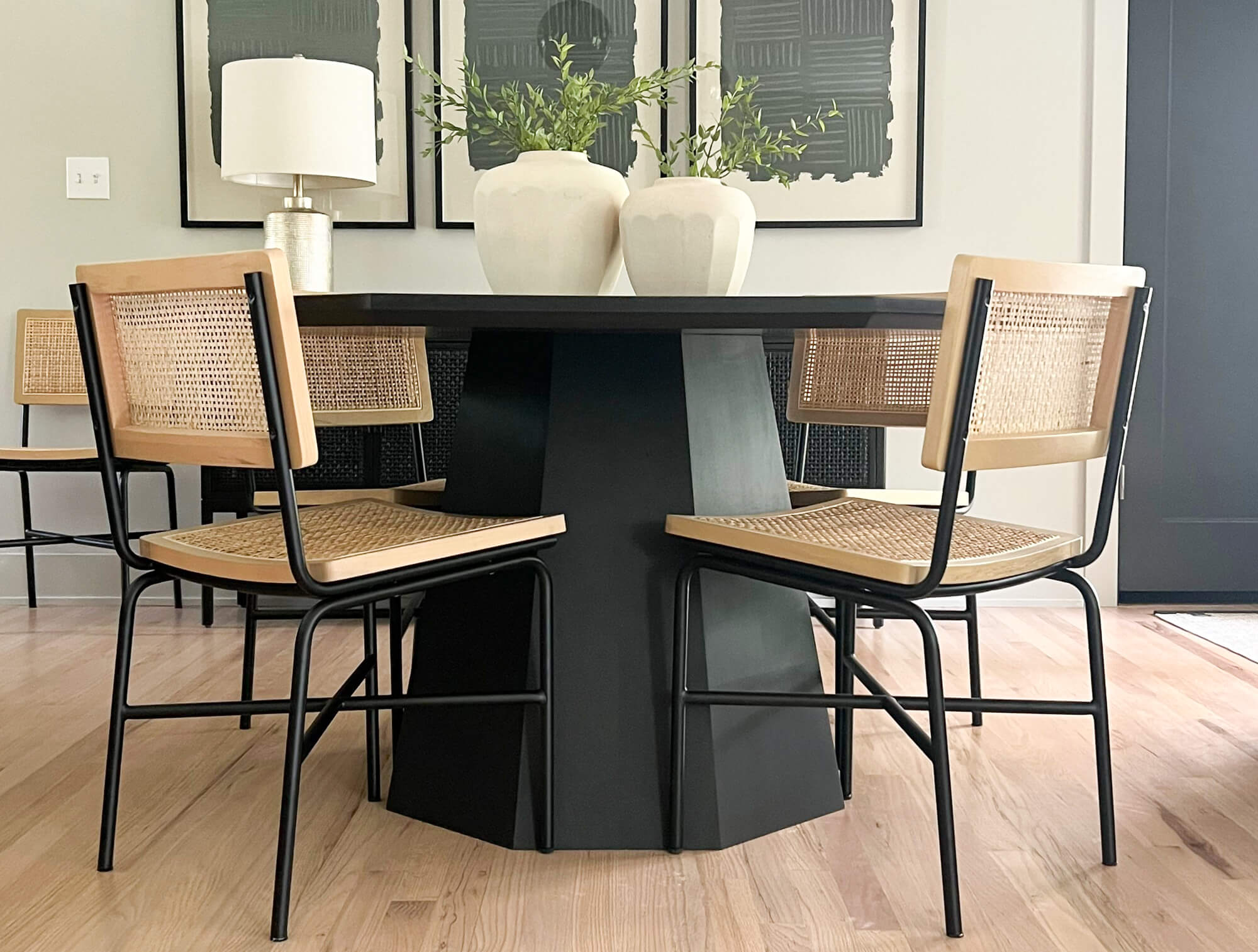 A black octagon shaped maple table with four chairs. Finished with Rubio Monocoat hardwax oil and stain products.