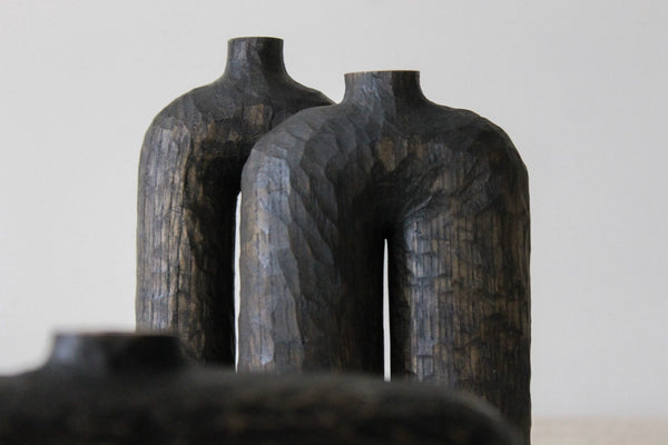 Two modern hand-carved wooden vases with curved elements and organic carved details. The vases were finished with Rubio Monocoat Oil Plus 2C hardwax oil finish.