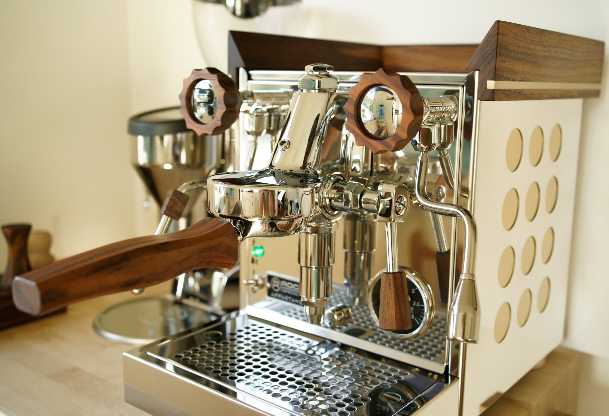 Luxury espresso machine with walnut wood accents finished with a hardwax oil wood finish.