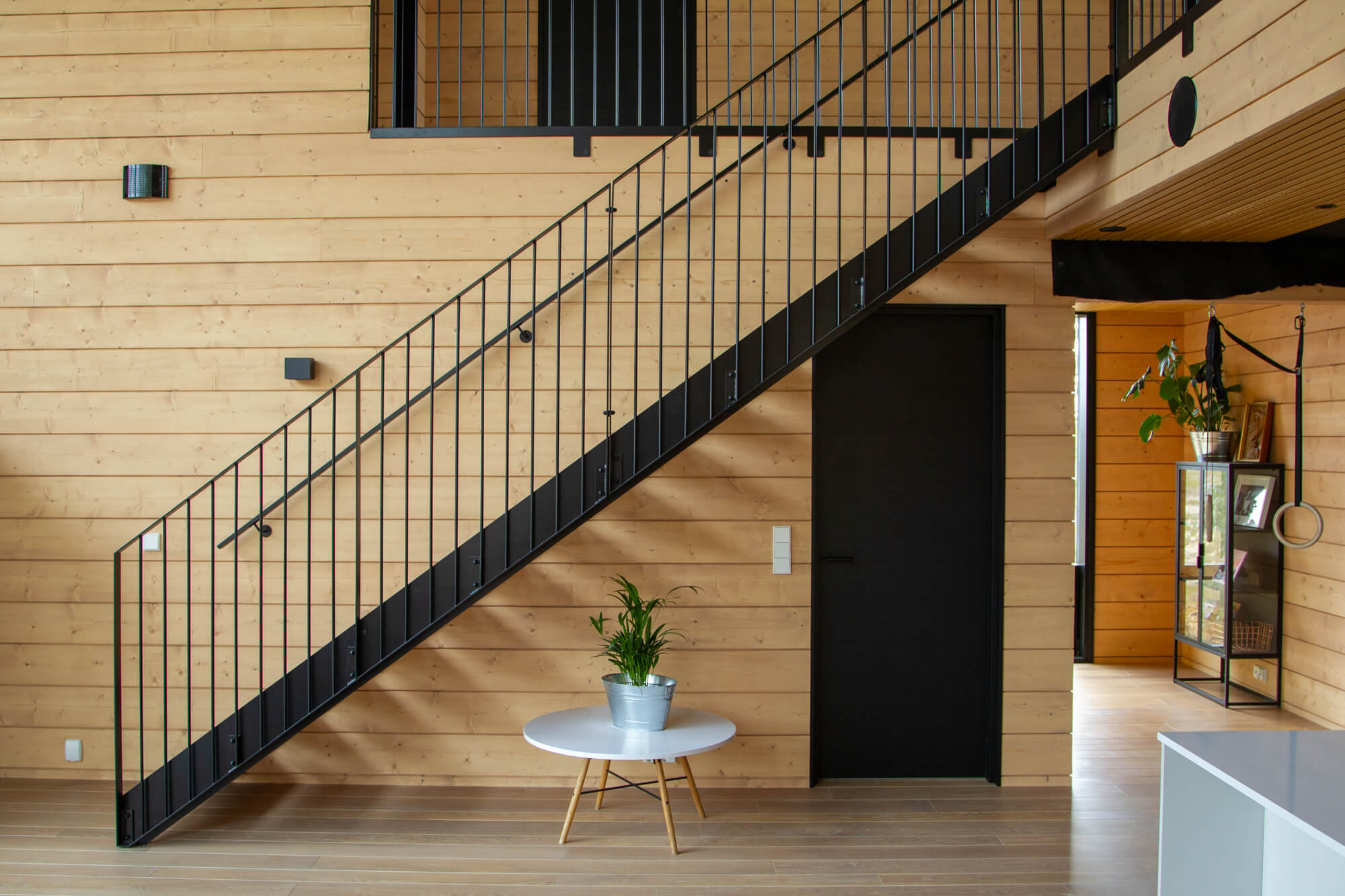 An open concept home with spruce paneling flowing throughout. The wood was finished in a custom Oil Plus 2C hardwax oil mixture.