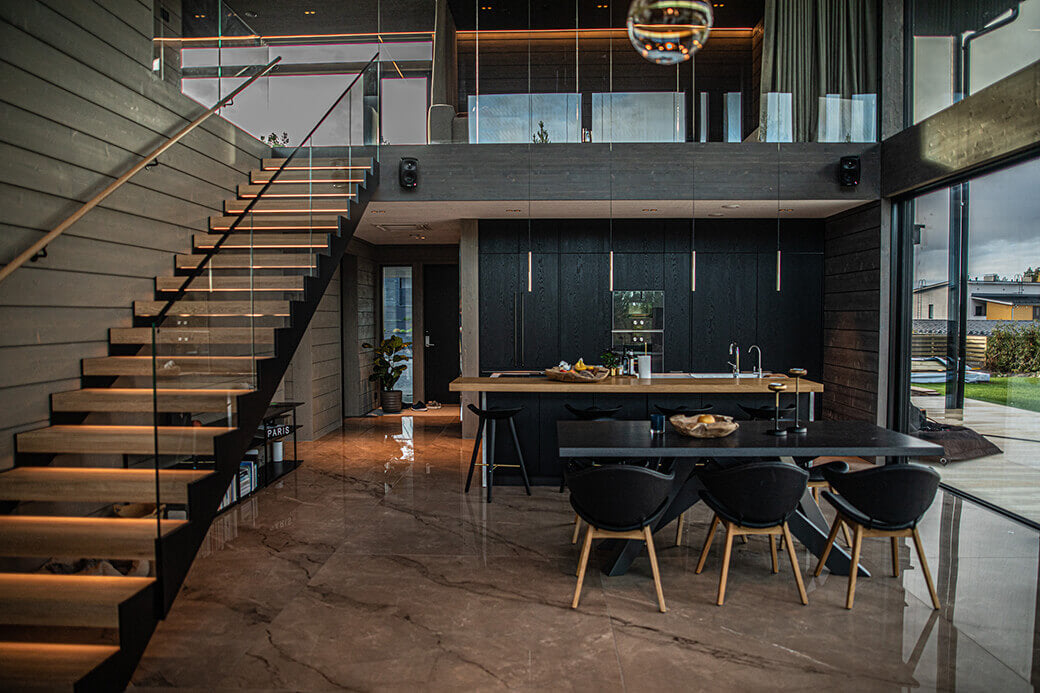 Modern open interior kitchen with natural lighting and a staircase