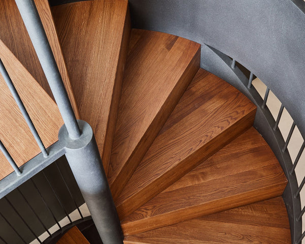 A spiral staircase made from European oak wood finished with Rubio Monocoat Oil Plus 2C hardwax oil wood finish offering increased protection for wooden floors.
