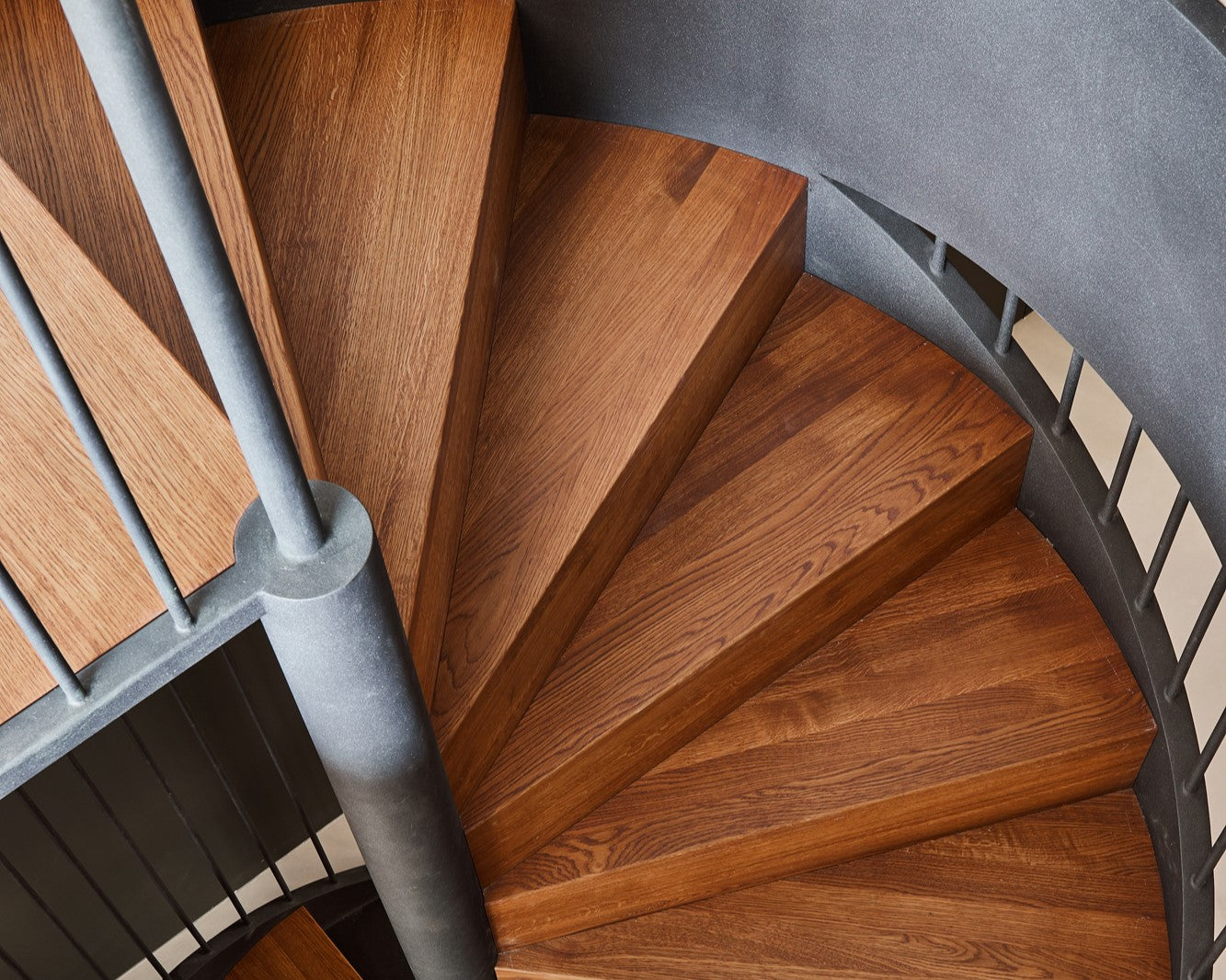 A spiral staircase made from European oak wood finished with Rubio Monocoat Oil Plus 2C hardwax oil wood finish.