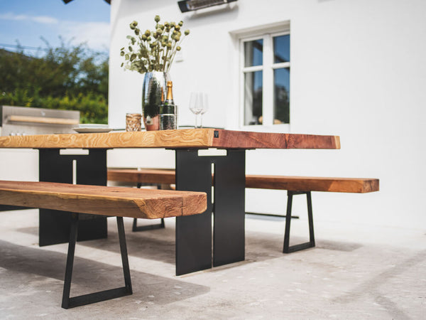 An outdoor dining set made from redwood and finished with Hybrid Wood Protector in the colour "Pure".