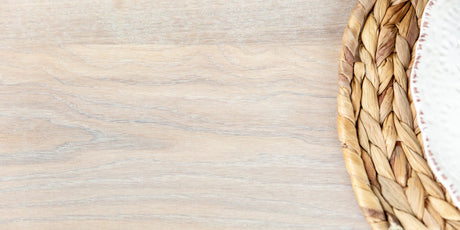 A light color wood finish on a dining table top.