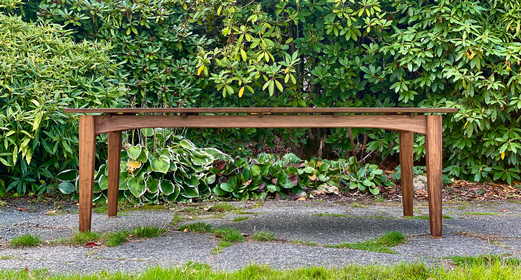 A walnut dining table finished with a wood oil finish.