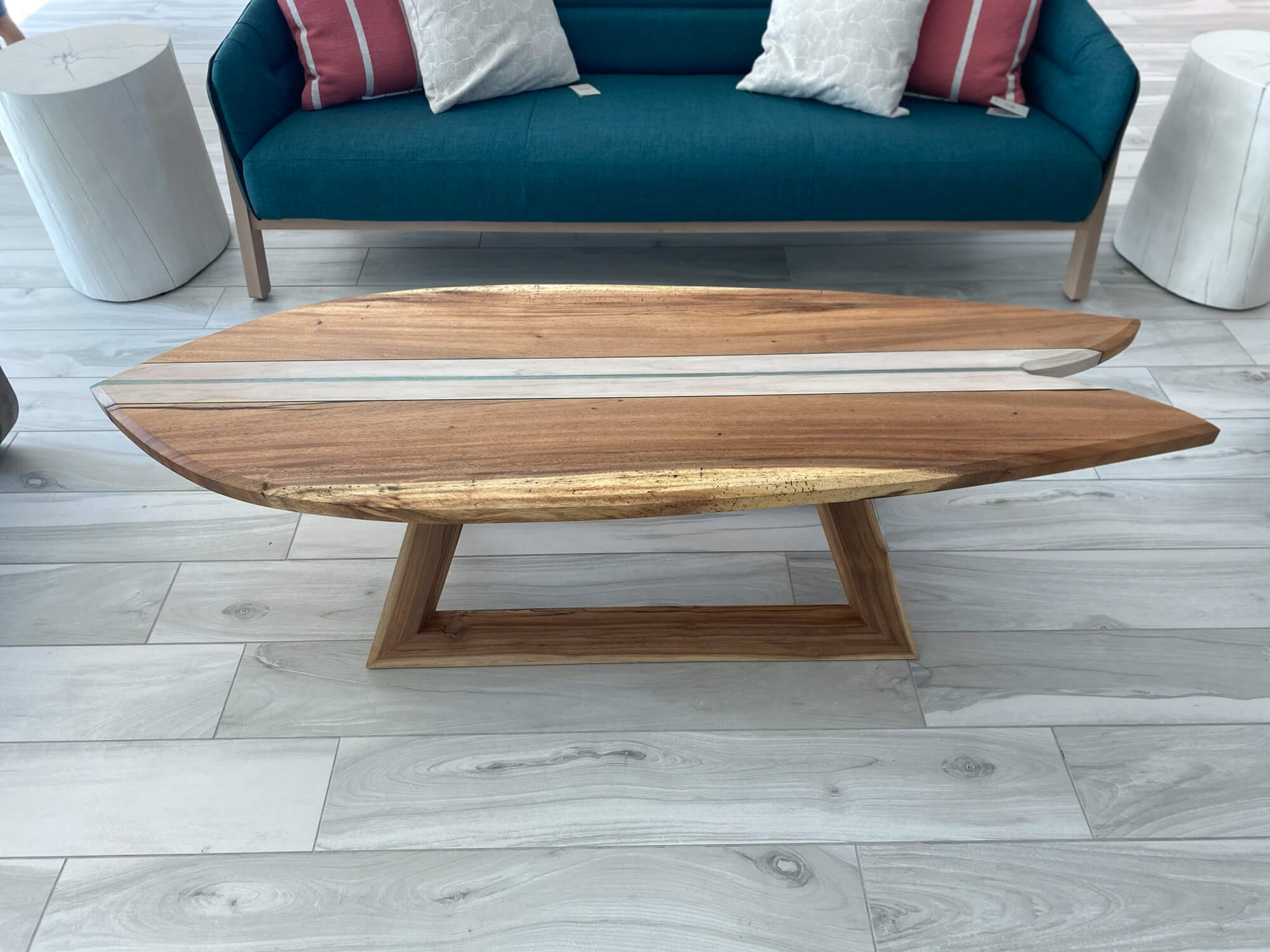 Wood coffee table shaped like surfboard made from monkeypod and teak. This wood project is finished with Rubio Monocoat hardwax oils.