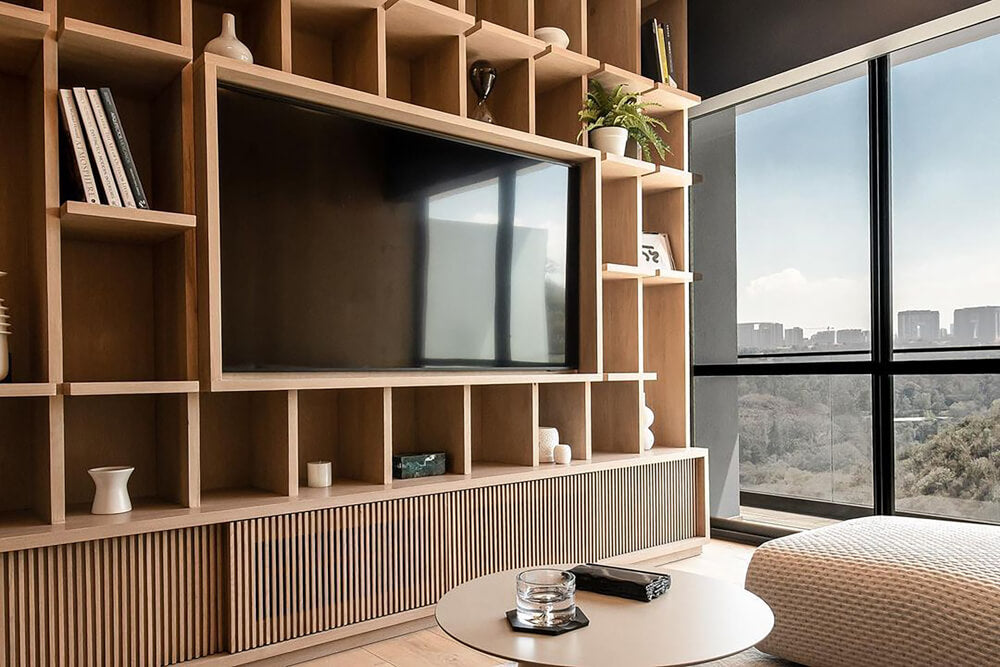 White oak built-ins offering a massive amount of storage were finished with Rubio Monocoat Oil Plus 2C. The living room looks out into the outdoors through several large windows.