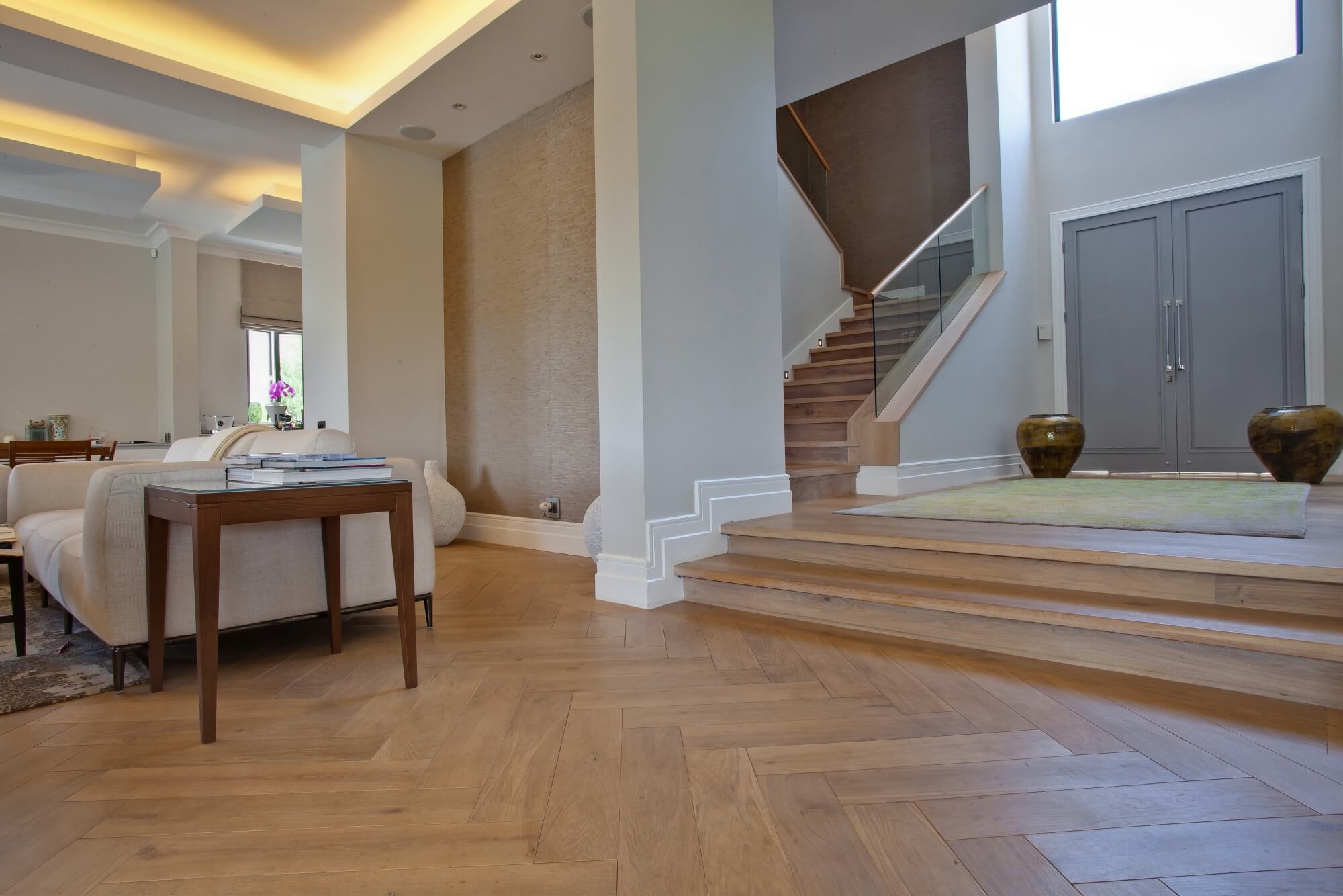 Herringbone oak flooring with a matte wood floor finish on it.