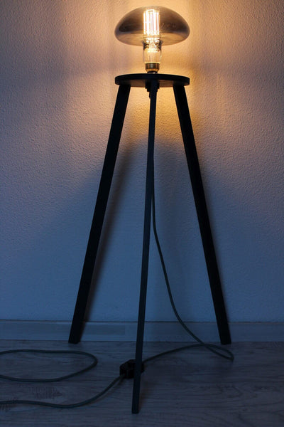 Wooden tripod lamp.