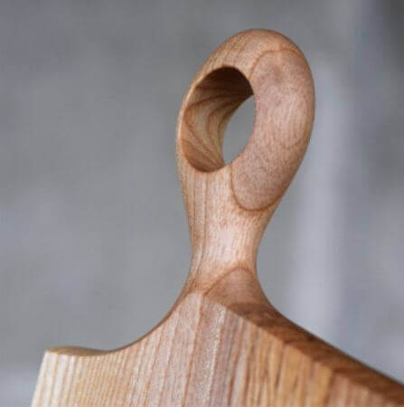 Handle on a wooden serving board finished with Oil Plus 2C.