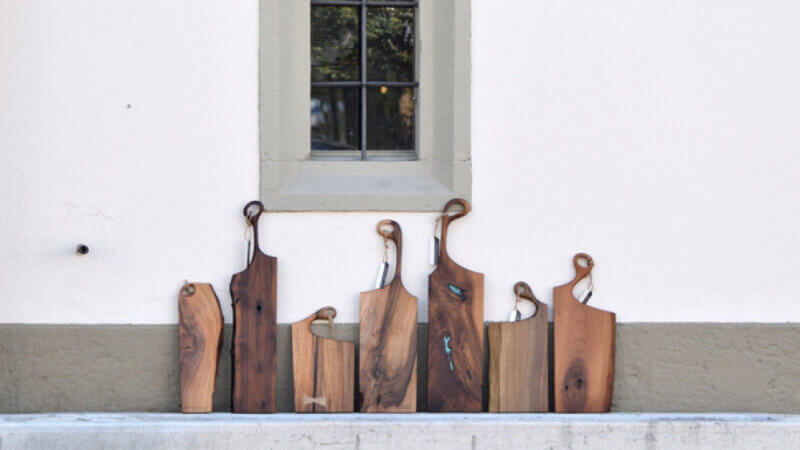 Wide variety of walnut serving boards finished with Rubio Monocoat Oil Plus 2C.