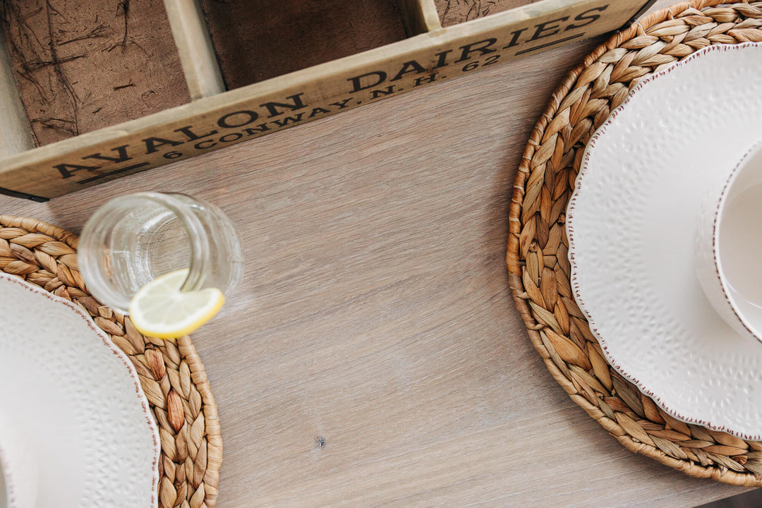 Several place settings and a table runner on a custom white oak dining table finished with Oil Plus 2C.