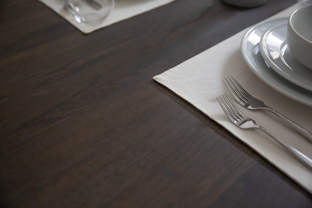 A white oak table finished with a bold, dark finish.