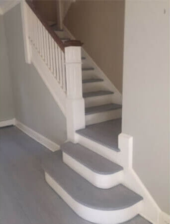 A red oak stair case and landing finished with Oil Plus 2C hardwax oil wood finish in the color Ash Grey.