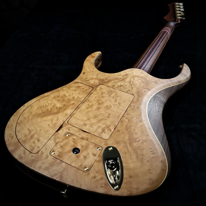 An image of the back of the madrone burl guitar.