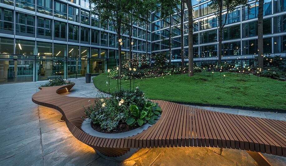 A nicely designed outdoor wood bench with a modern geometric twist to it.