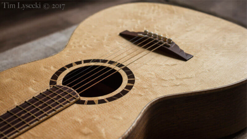 An acoustic guitar with birdseye maple finished with a hardwax oil.