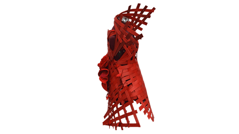 Side profile of a red dress made out of wood strips.