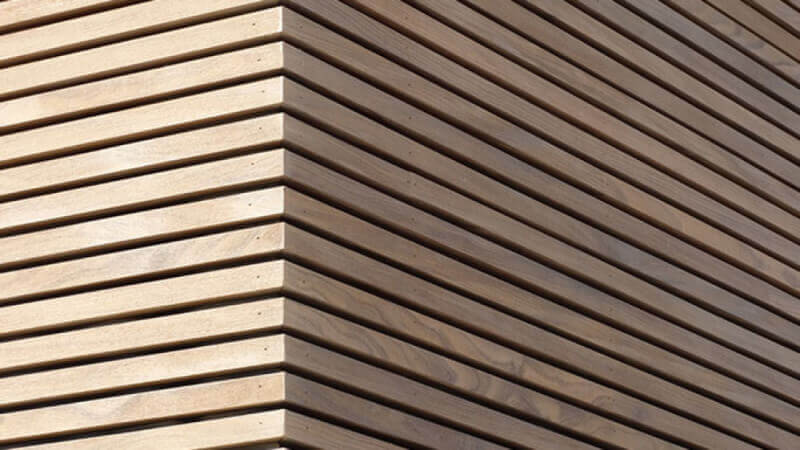 The corner of a wood facade finished using Hybrid Wood Protector.