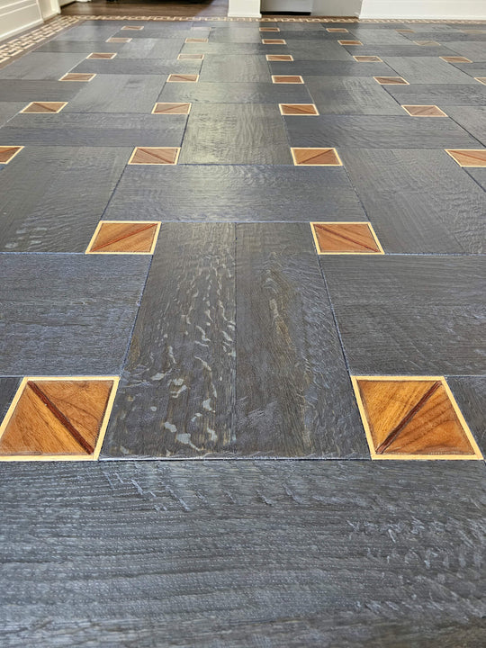 Close up of a white oak basketweave patterned floor finished in a blue hue.