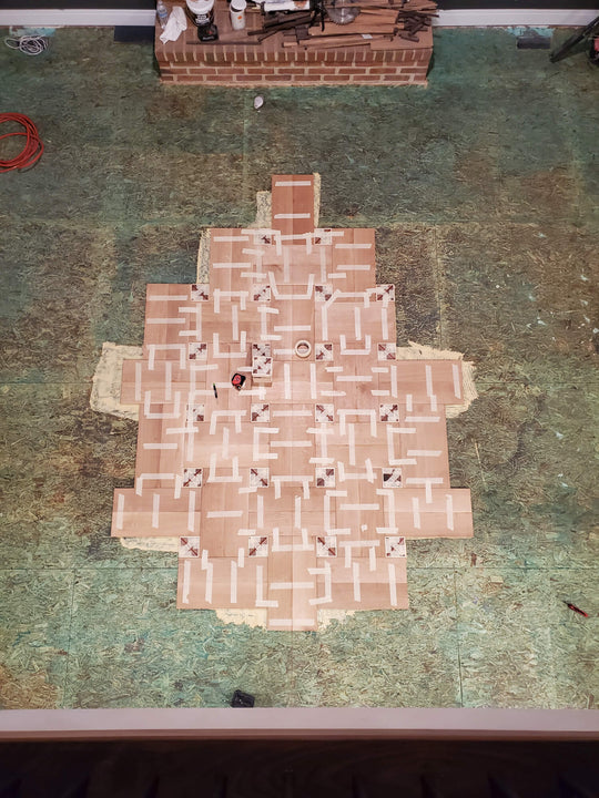 The beginning of laying a basketweave hardwood patterned wood floor.