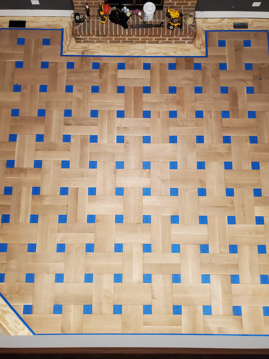 Unfinished basketweave patterned hardwood floor.