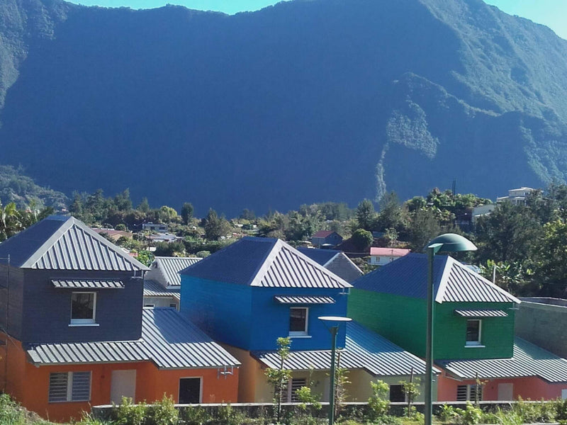 A collection of condos with fun and colorful siding.