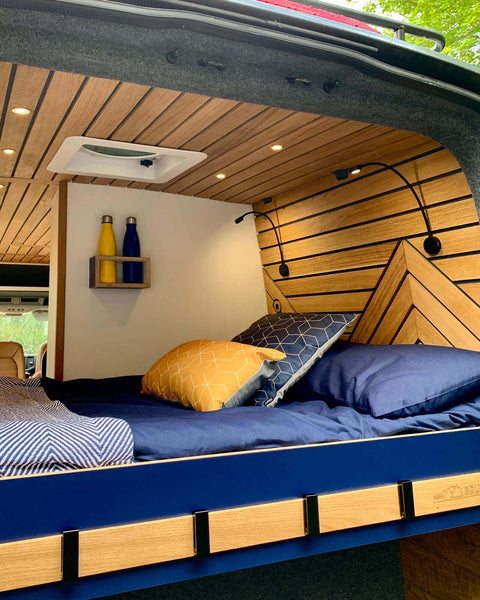 Another angle of the mobile camper van bed. Oak accents in this van are visible and finished with Rubio Monocoat Hybrid Wood Protector.