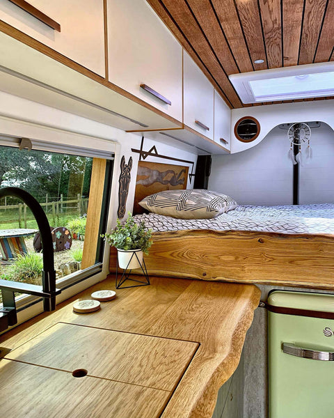 Oak live edge countertop in conversion camper kitchen.