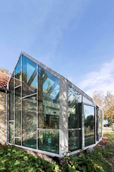 Glass sun room attached to house.