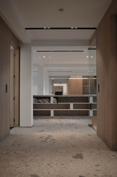 Interior designed office space with wood cabinets and stone flooring.