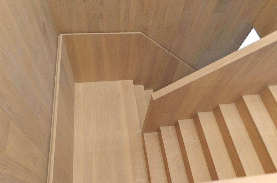 Wood staircase in an office building with natural looking oak wood.