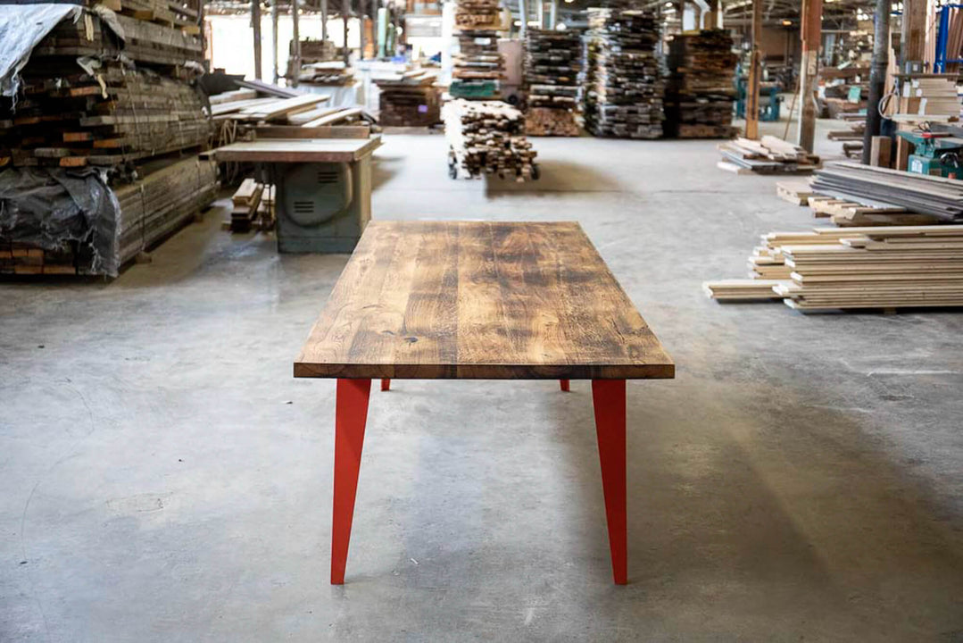 Charred oak table with blue metal legs finished with Rubio Monocoat Oil Plus 2C hardwax oil wood stain and finish.