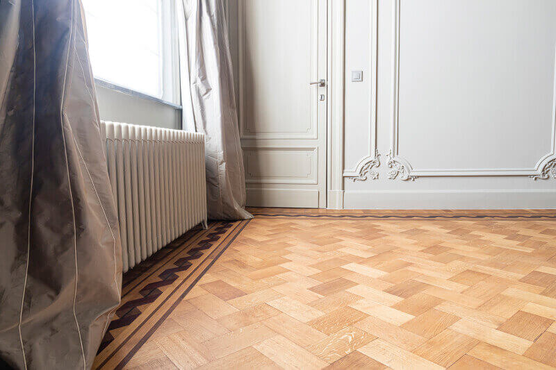 Hardwood flooring in house with border inlay.