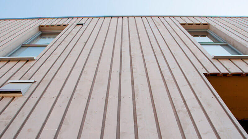 Exterior wood finish on wood paneled building.