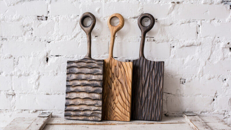 Wooden serving boards with hand carved textures on them.