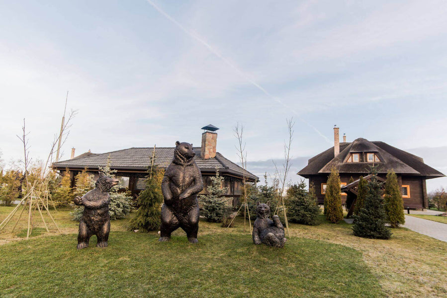 Front of property that features three bear statues and many wood features finished with Rubio Monocoat.