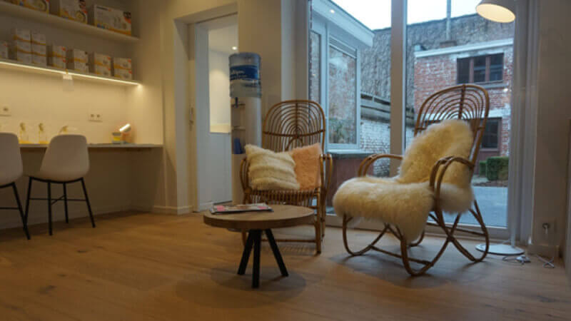 Unique rocking chairs in clothing store sitting on wooden floors finished with Rubio Monocoat.