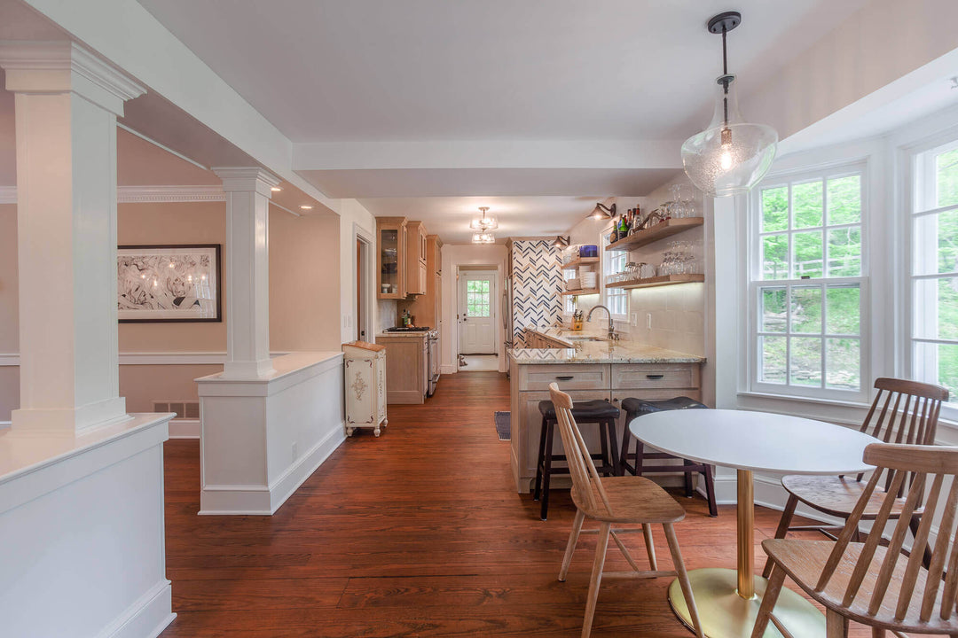 Kitchen with light rift sawn white oak cabinetry and dark warm floor.